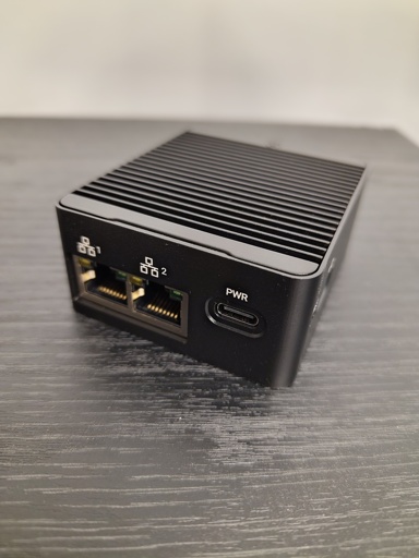 A black metal box with two network ports.